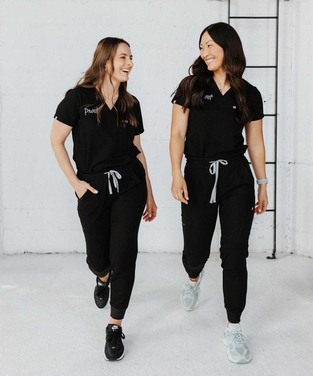 Liz Gilroy and Diana Limonov walking together in Proof scrubs.